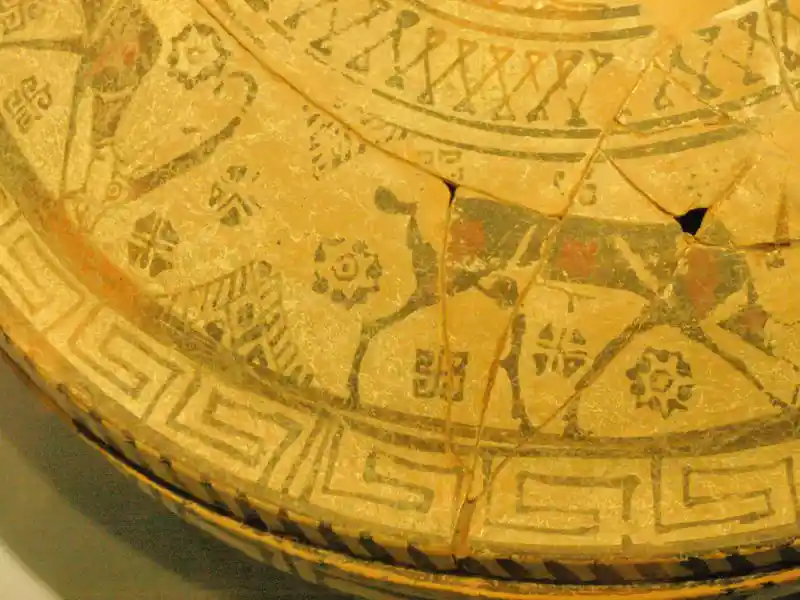 Solar crosses, four-footed animals, square spirals, interlocking triangle sun rays painted on a lid.
